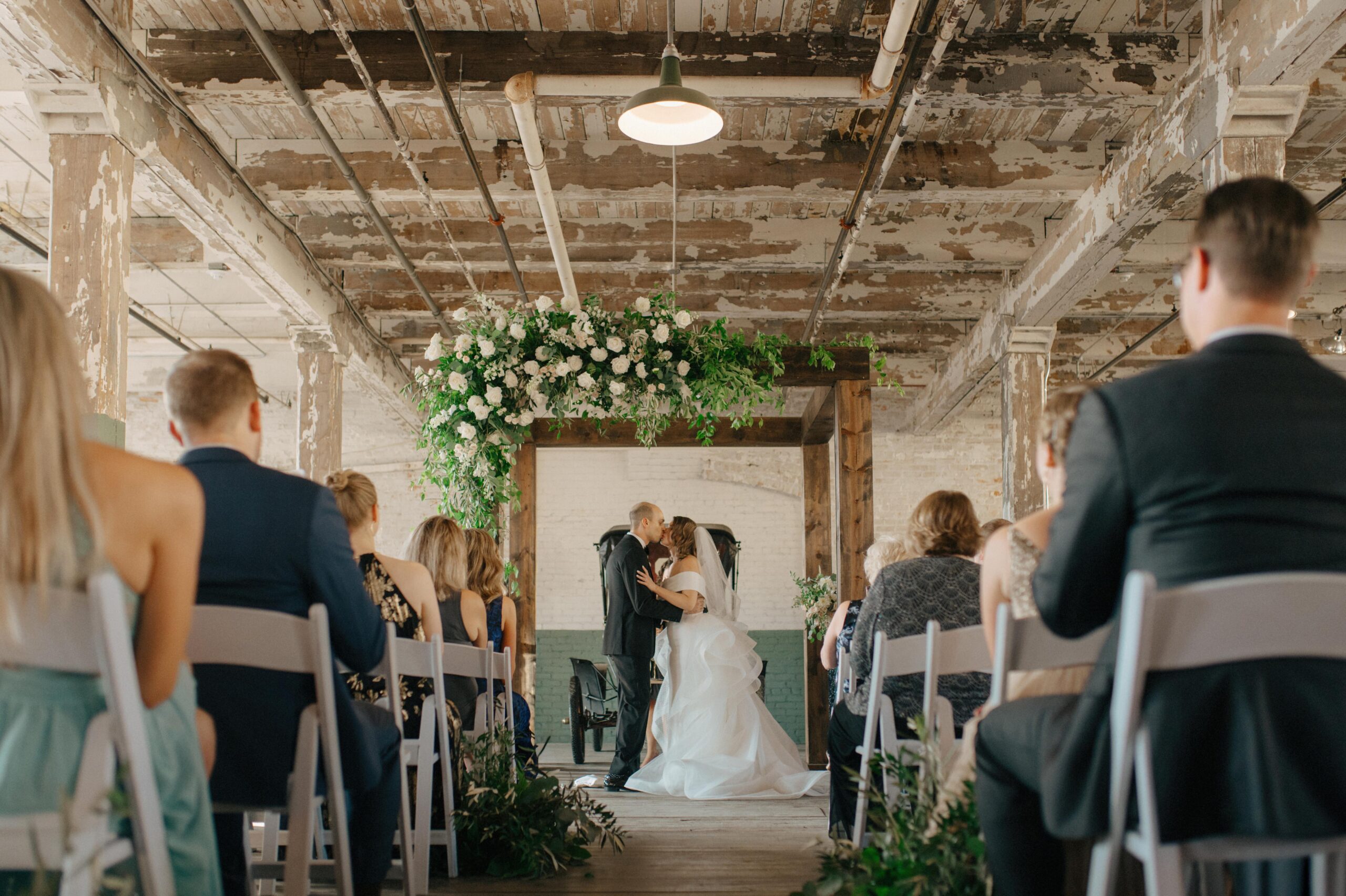A Ford Piquette Plant wedding ceremony in front of a Model T.