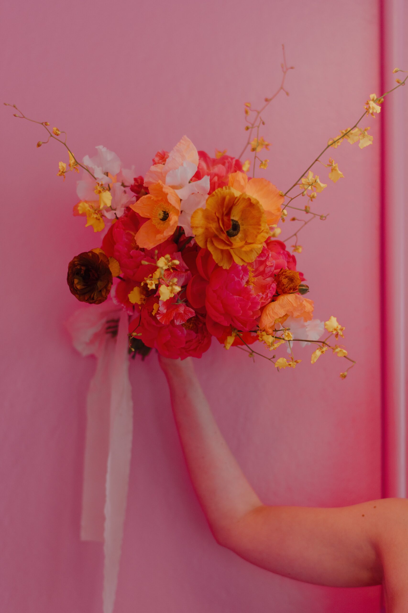 Detail shot of bright pink, coral, and yellow bouquet.