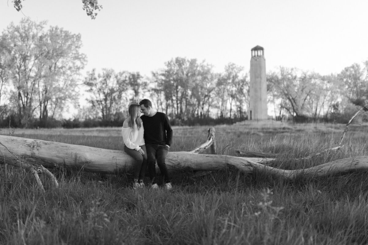 A couple posing in front of the lighthouse at Belle Isle
